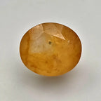 Ceylon Yellow Sapphire gemstone on a light gray background online India