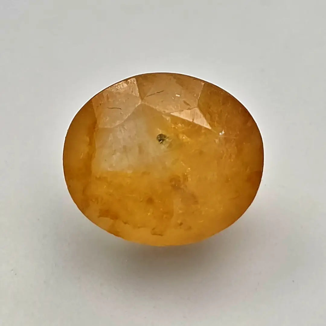 Ceylon Yellow Sapphire gemstone on a light gray background online India
