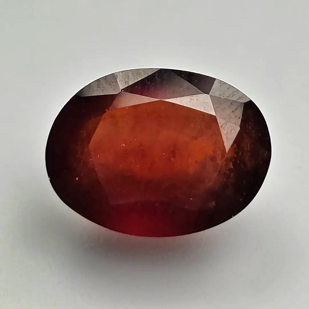 Faceted red gemstone on a light gray background online India
