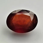 Faceted red gemstone on a light gray background online India