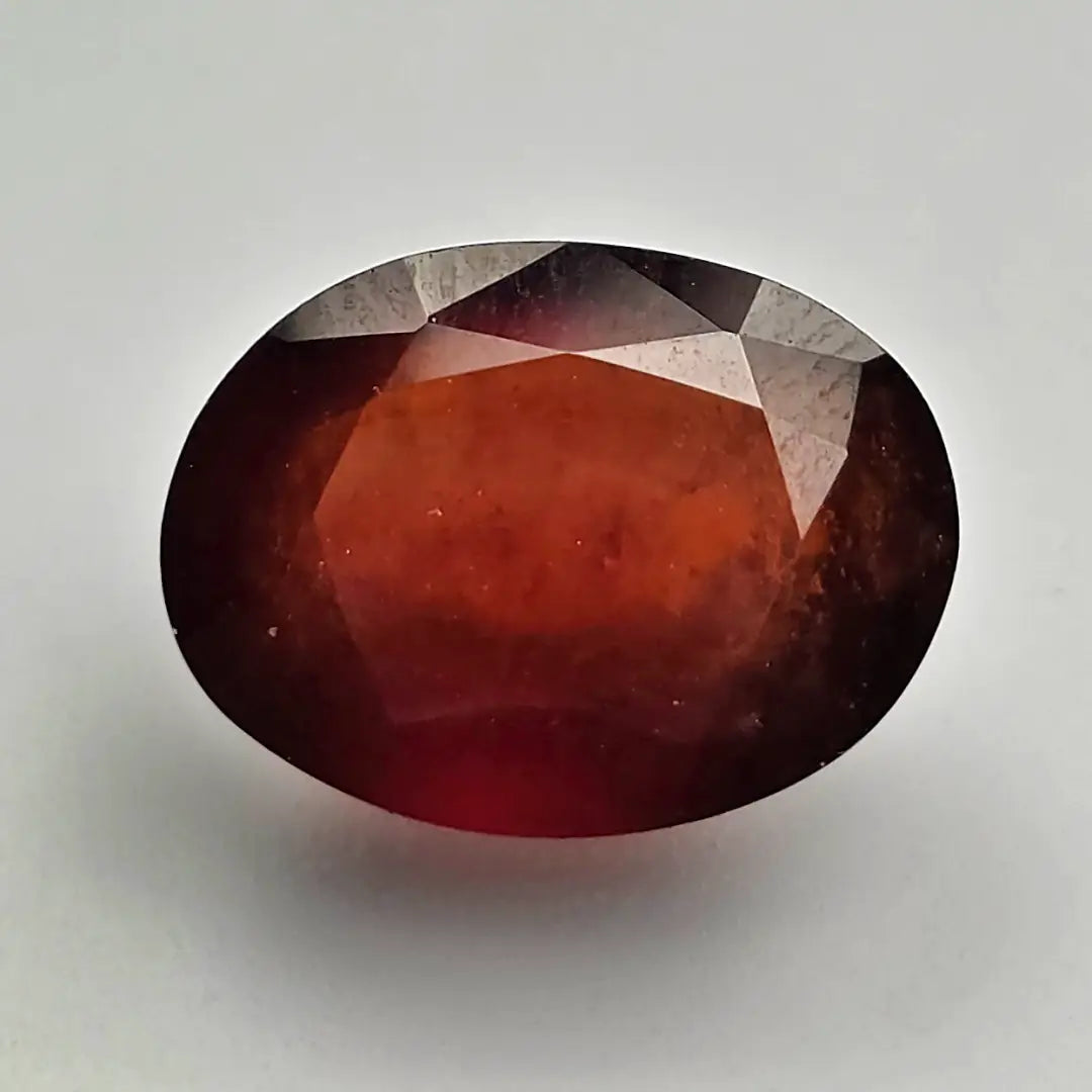 Faceted red gemstone on a light gray background online India