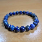 Lapis Lazuli Blue beaded bracelet on a wooden surface