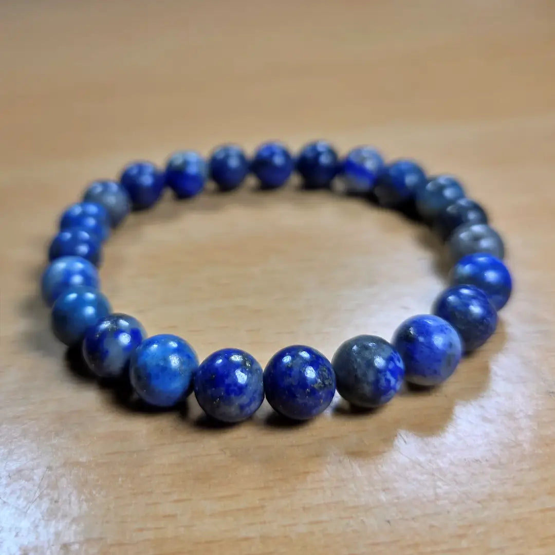 Lapis Lazuli Blue beaded bracelet on a wooden surface