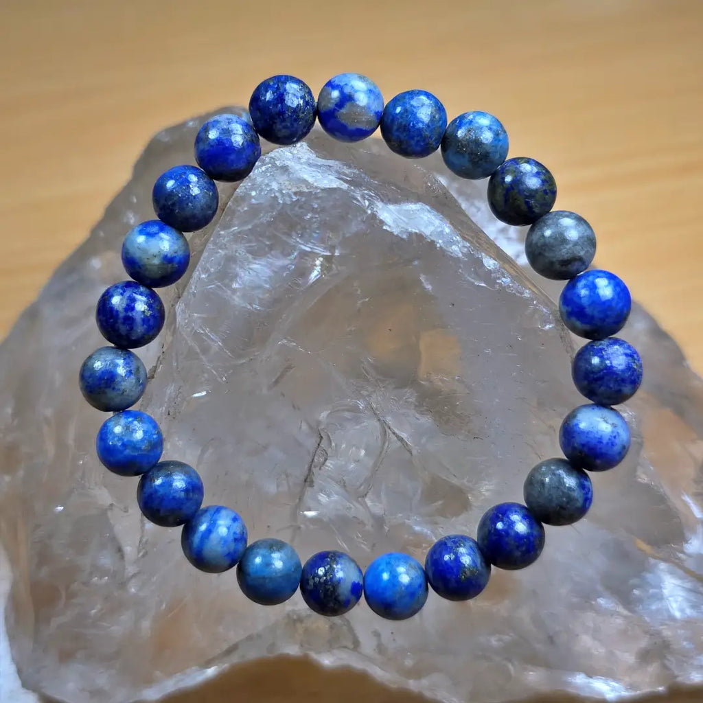 Lapis Lazuli beaded bracelet on a clear crystal background