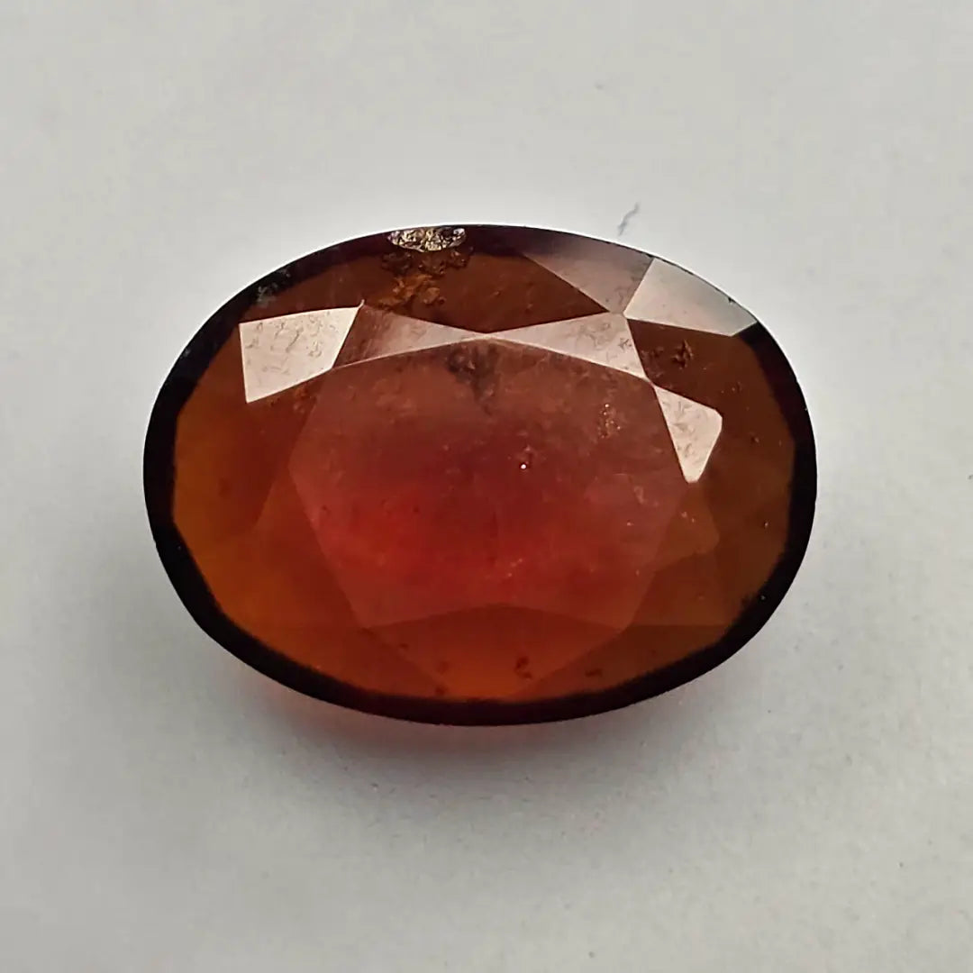 Faceted red gemstone on a light gray background online India