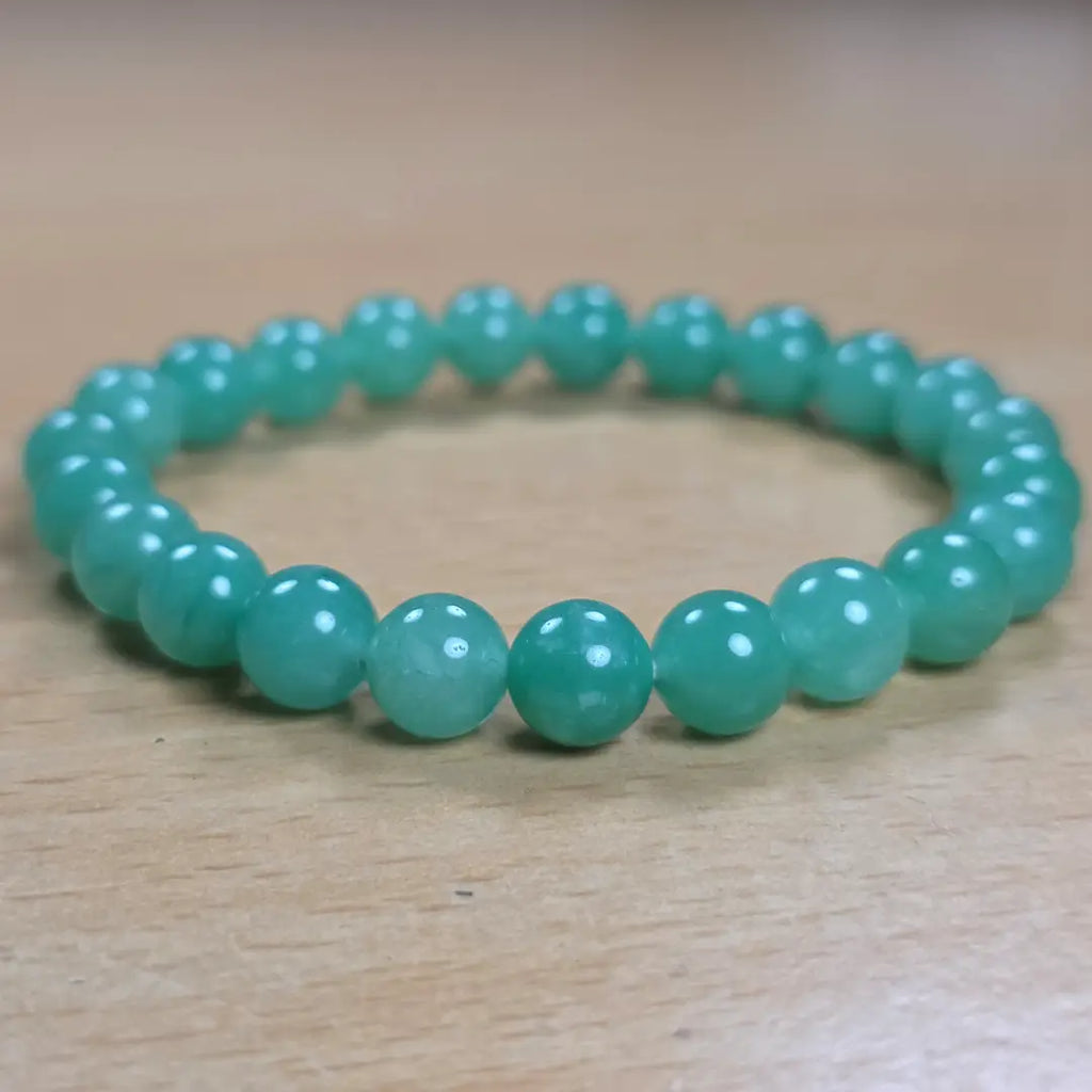Green aventurine bracelet on a wooden background