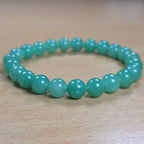 Green aventurine bracelet on a wooden background