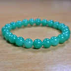 Green aventurine bracelet on a wooden surface
