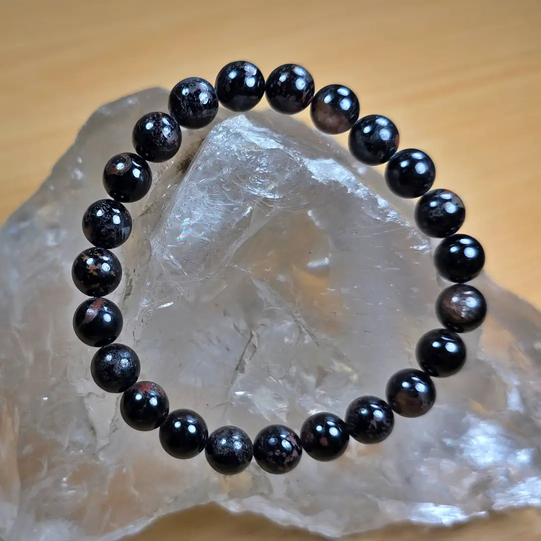 Black tourmaline bracelet on a clear crystal
