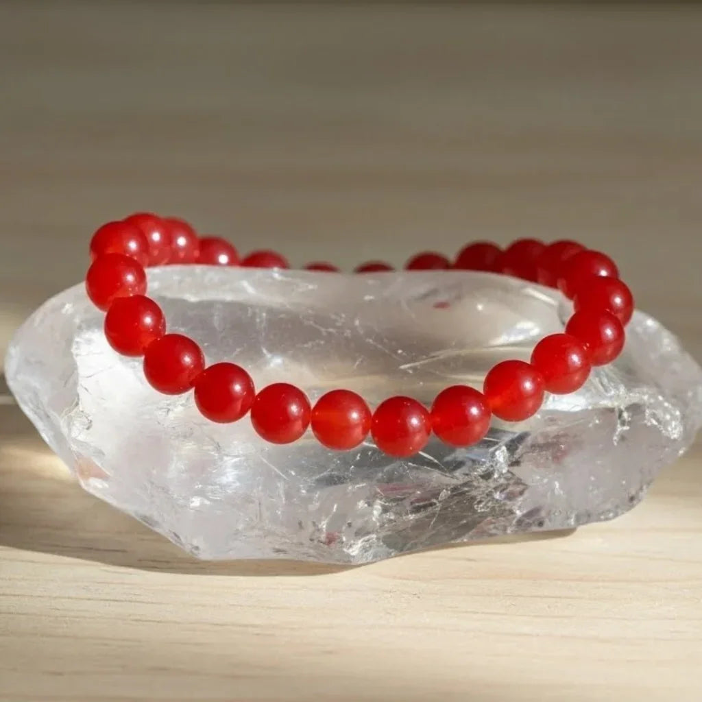 carnelian bracelet on a clear crystal with a neutral background