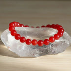 carnelian bracelet on a clear crystal with a neutral background