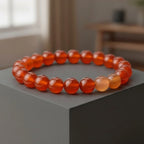 carnelian bracelet on a gray surface with a blurred indoor background