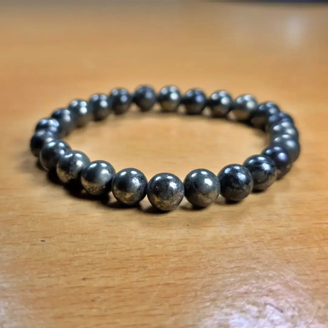 Black beaded bracelet on a wooden surface