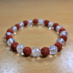 Bracelet with red and white beads on a wooden surface