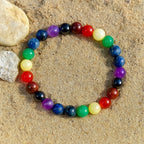 Multicolored 7 chakra bracelet on a sandy surface