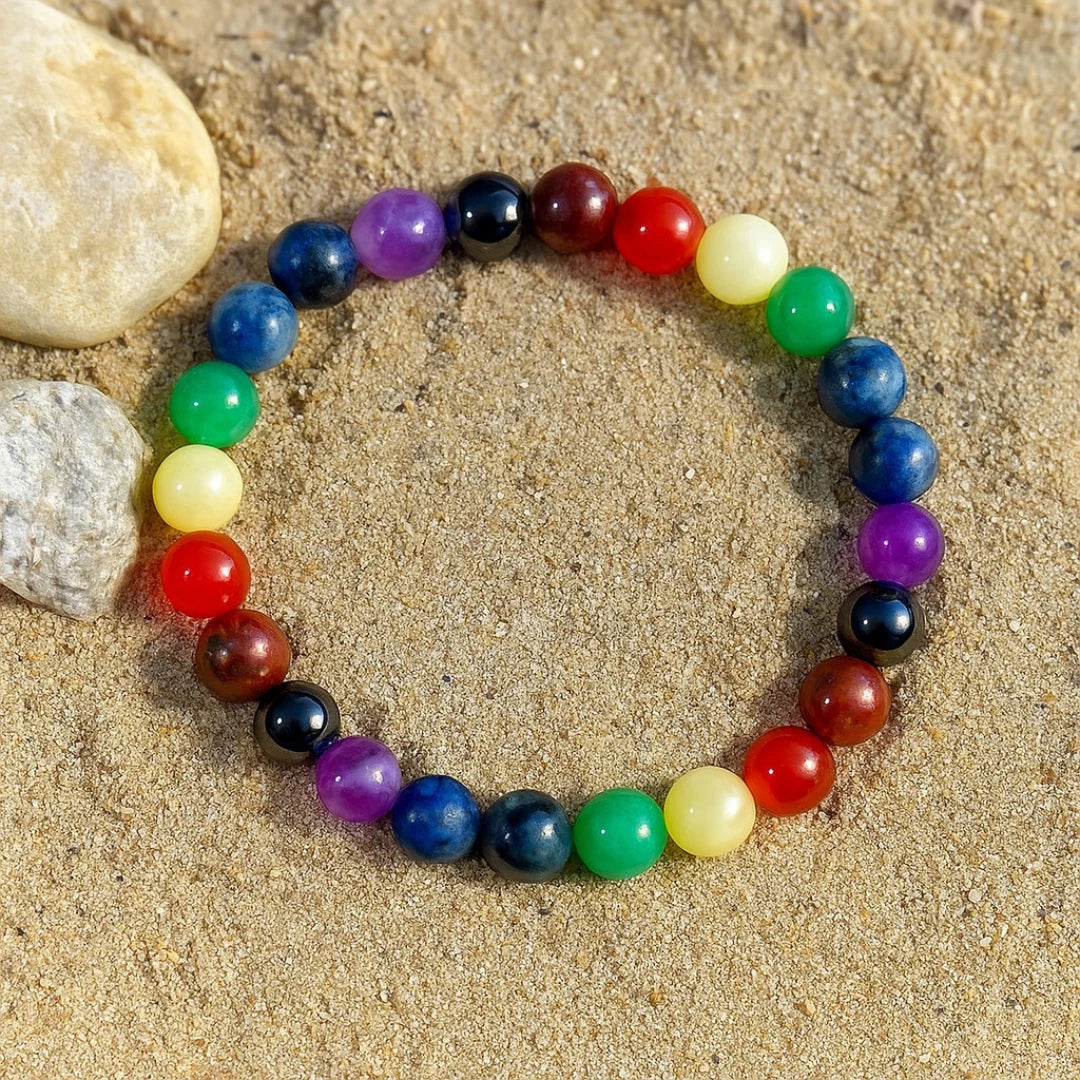 Multicolored 7 chakra bracelet on a sandy surface