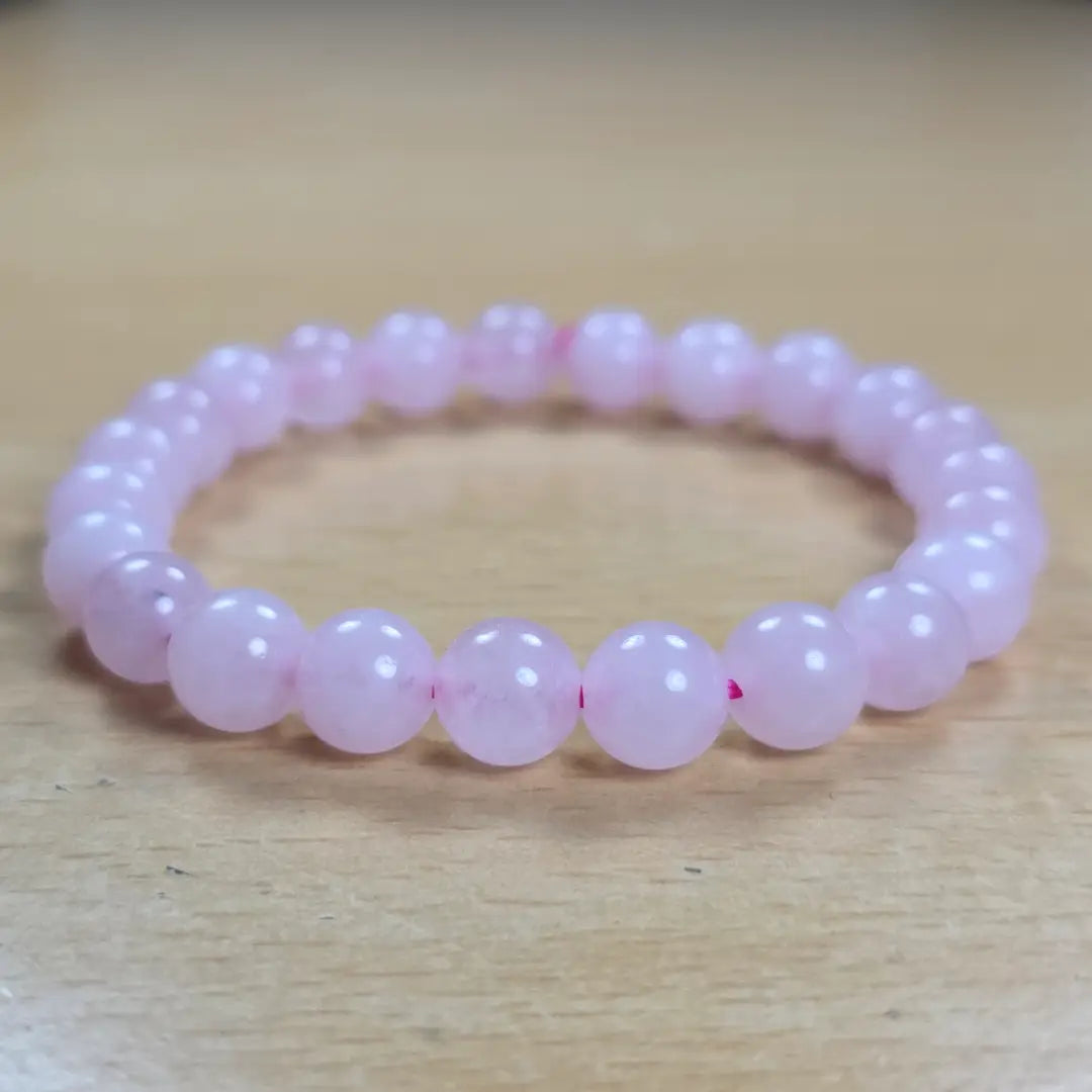 stylish rose quartz bracelet on a wooden surface