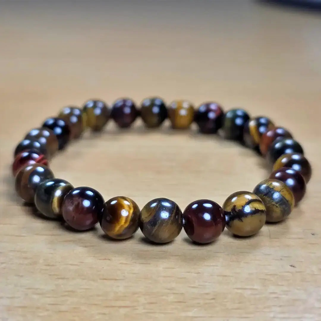 tiger eye bracelet with multicoloured stones on a wooden surface