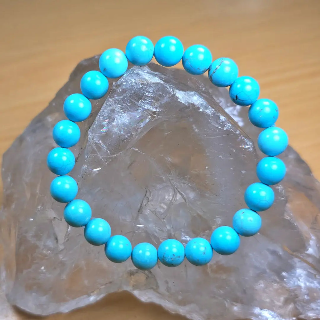 Turquoise beaded bracelet on a clear crystal rock