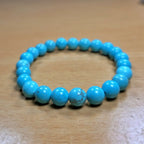 Turquoise beaded bracelet on a wooden surface
